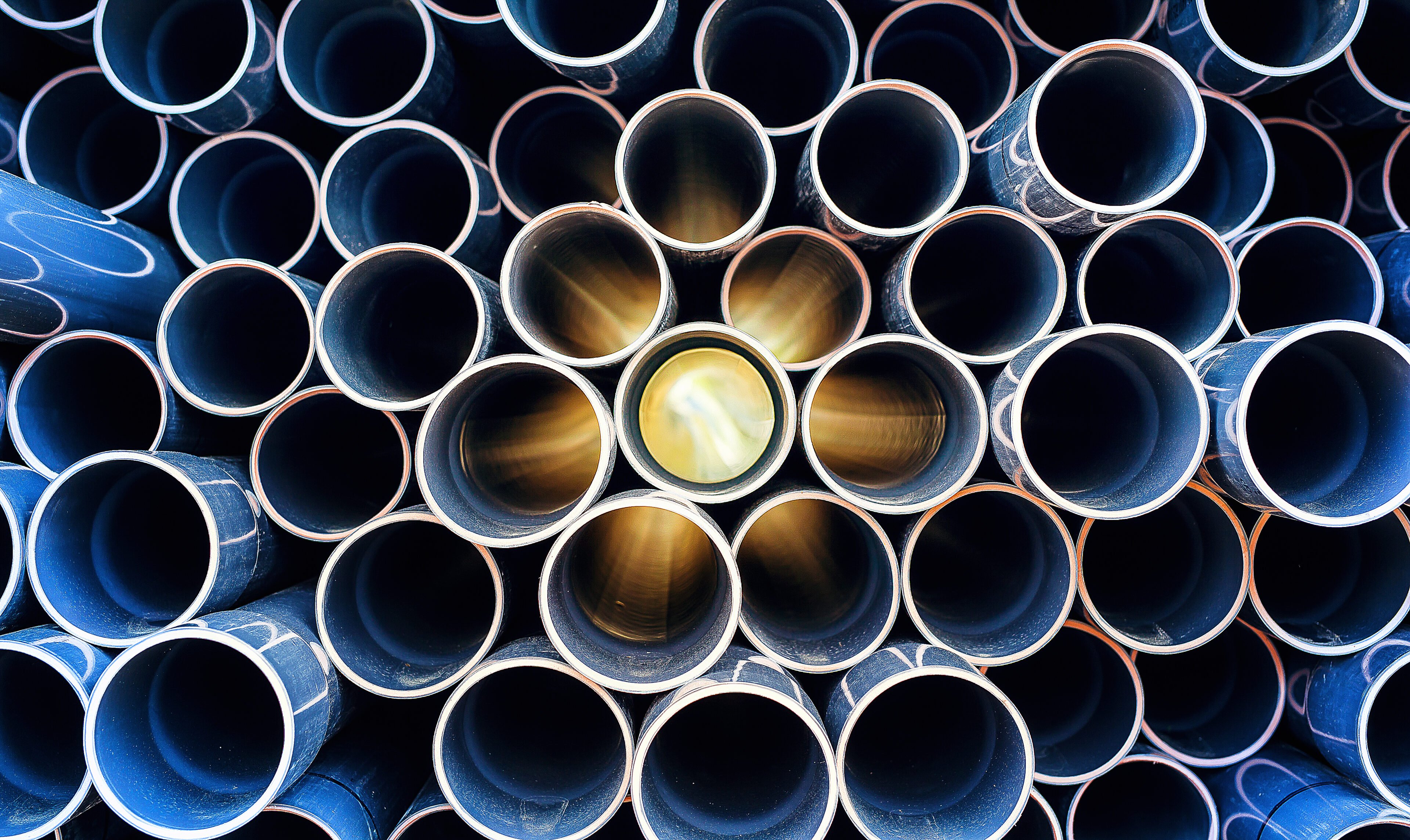 Abstract pattern of scratched pvc pipe piled up with sun lights coming through the middle