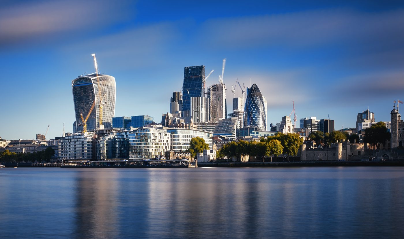 Photograph of London City Skyline at River Thames. Blue sky and sunny day