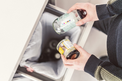 Arial shot of someone recycling two glass jars